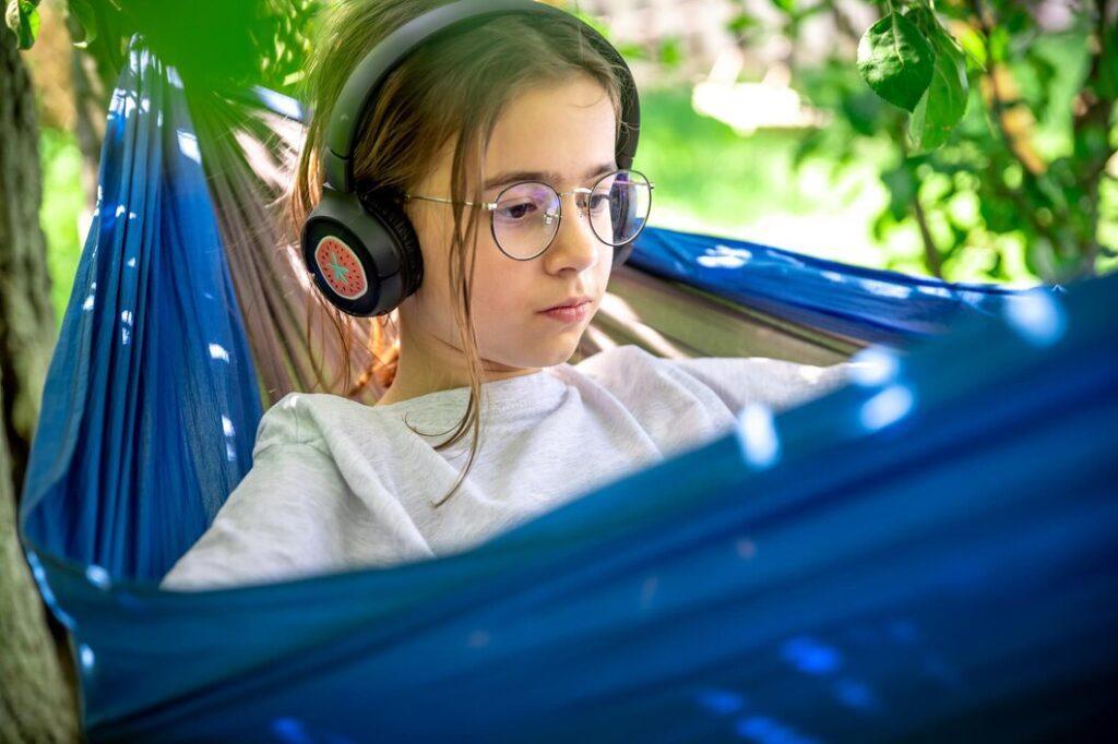 girl with tablet hammock garden 169016 39098 Use audiobooks for car rides or quiet time