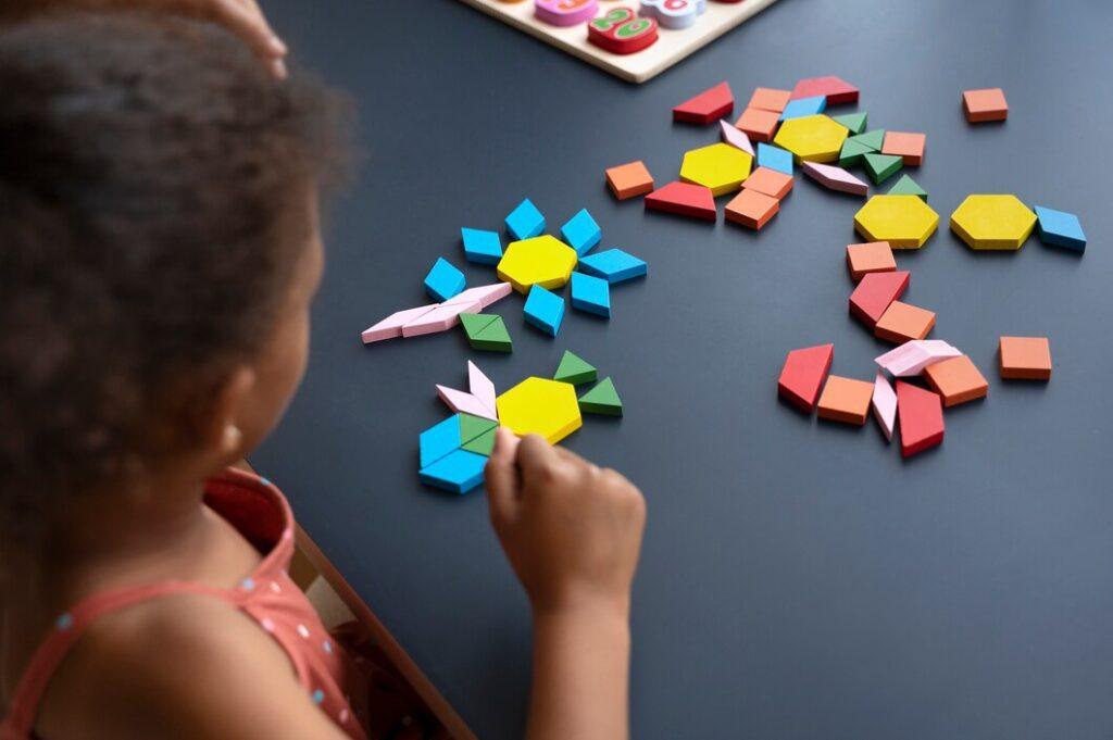 high angle girl making puzzle 23 2149557913 Shapes Are the Secret Language