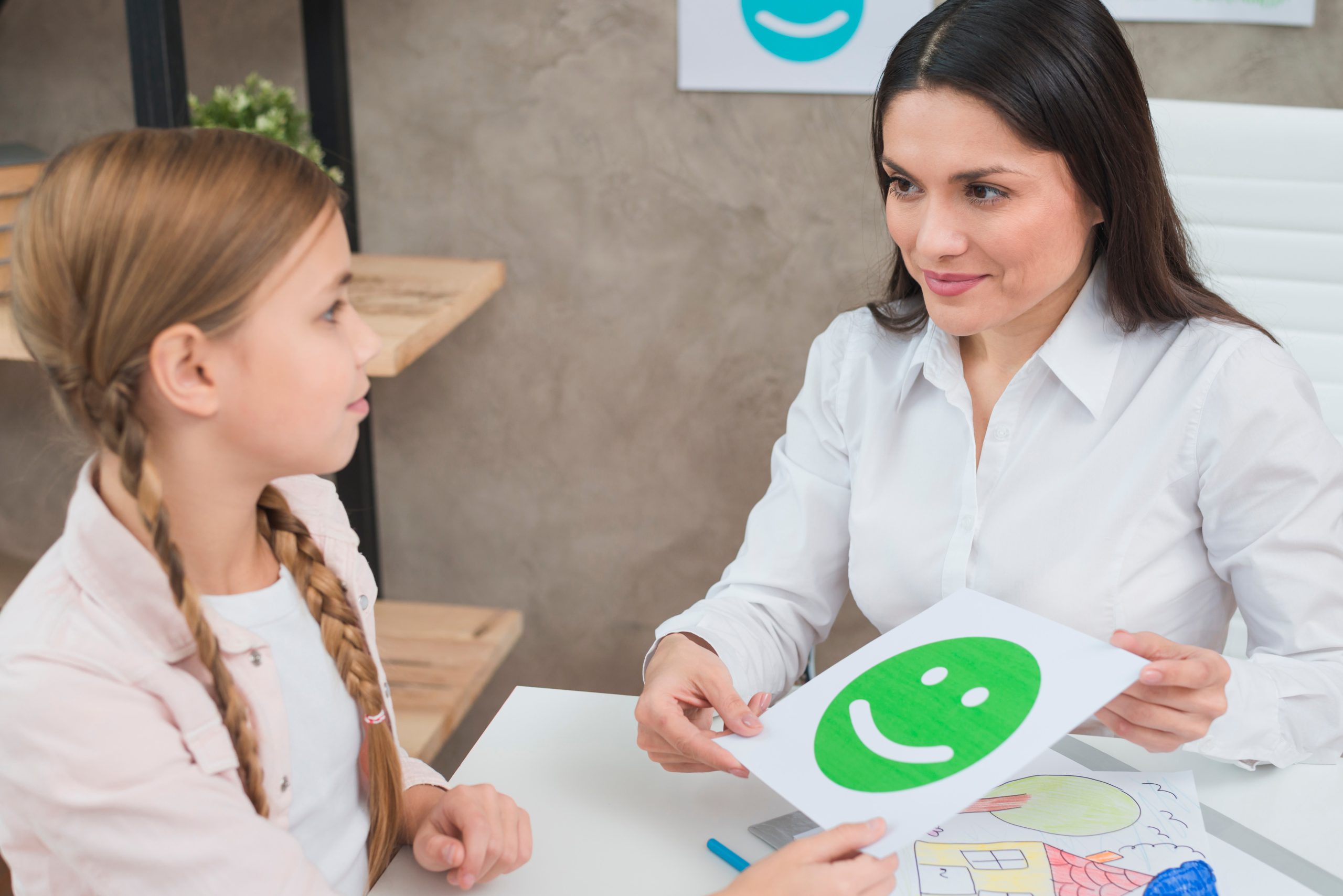 friendly young female psychologist girl holding happy emotion face card 1 scaled